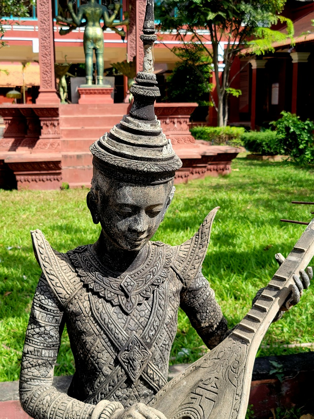 a statue of a person holding a guitar