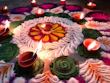Colorful garlands and vibrant rangoli powders arranged gracefully for festival celebrations.