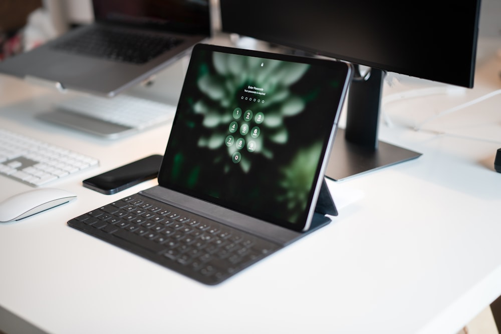 a laptop computer sitting on top of a white desk