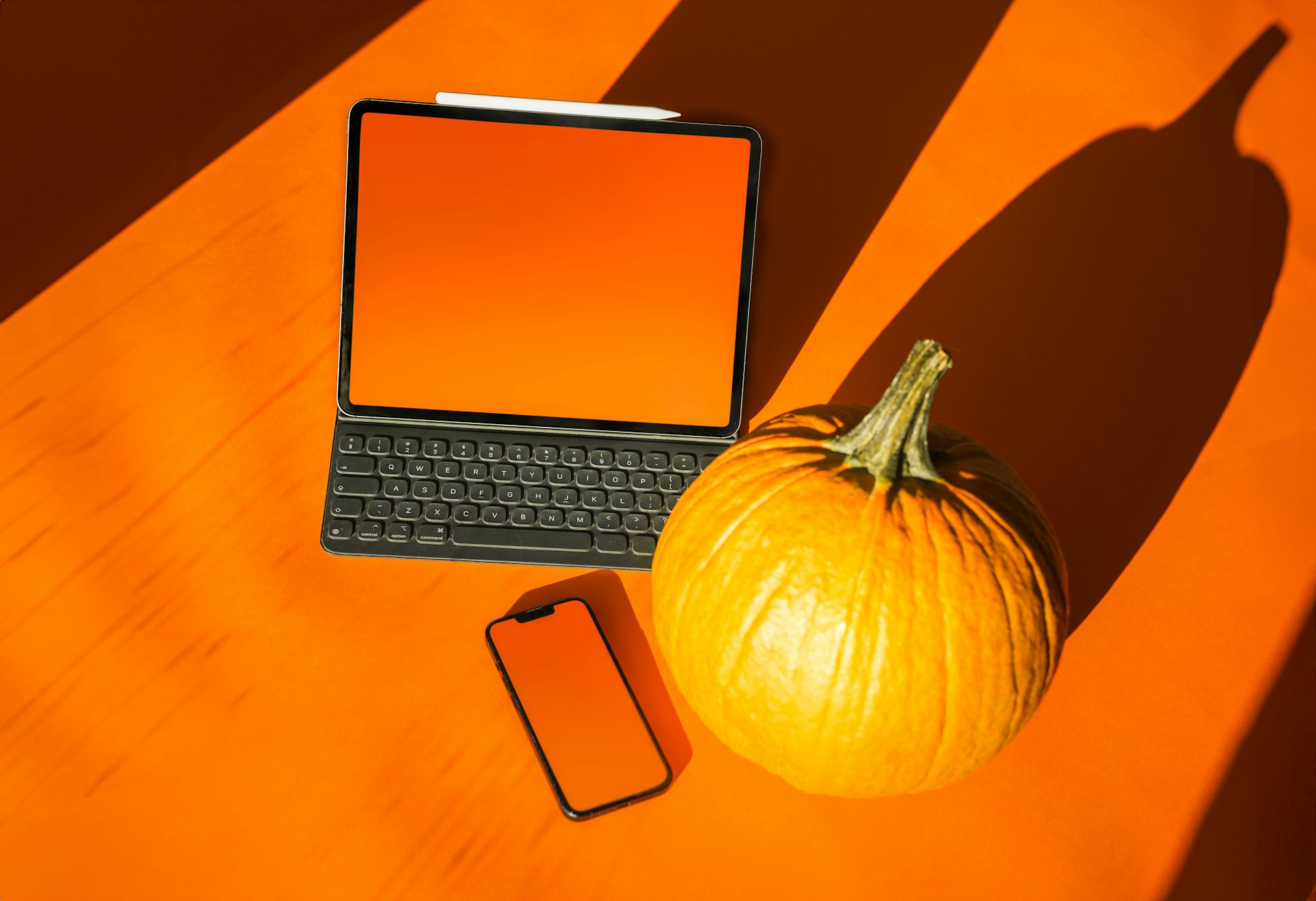 a laptop computer sitting on top of a table next to a pumpkin