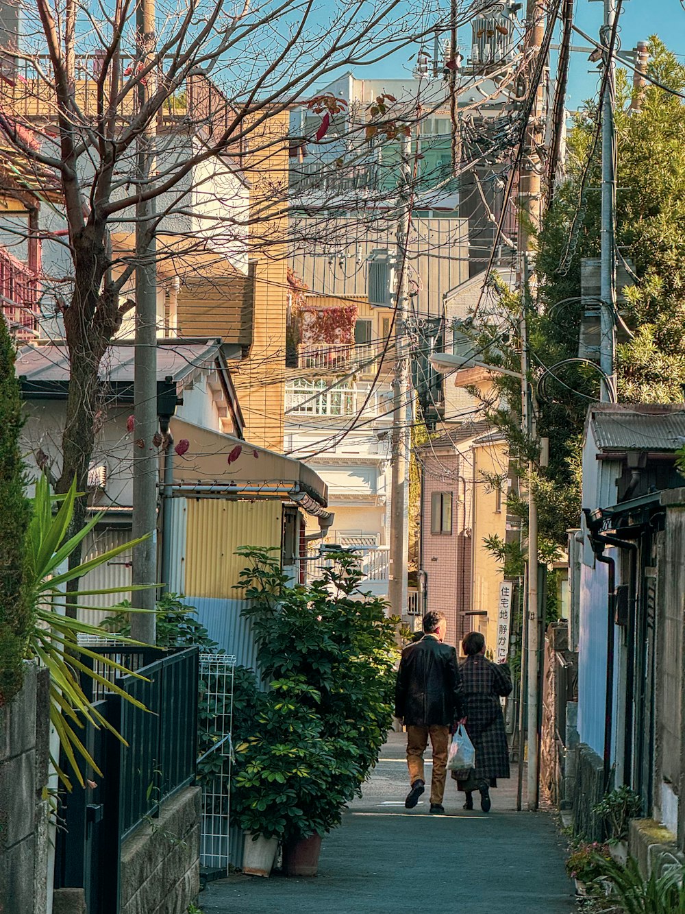 a couple of people that are walking down a street