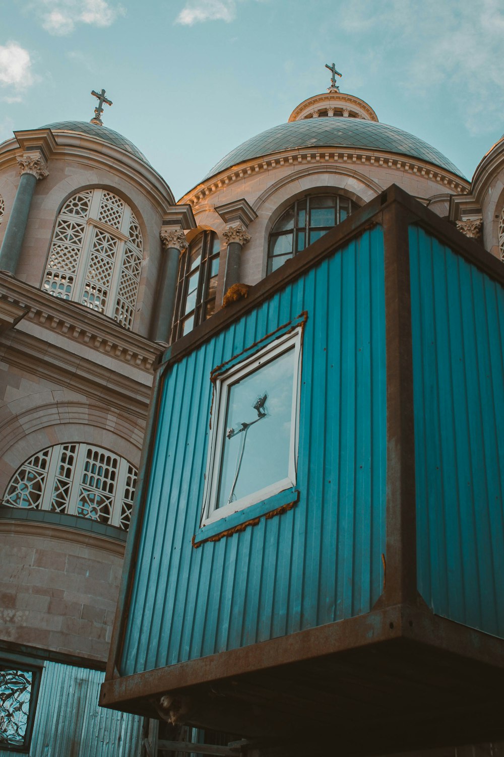 a blue building with a clock on the side of it