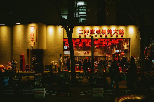 A vibrant street view of a popular local eatery with colorful signage and outdoor seating.