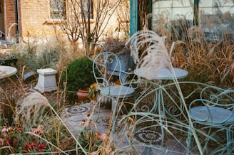 a couple of chairs and a table in a garden