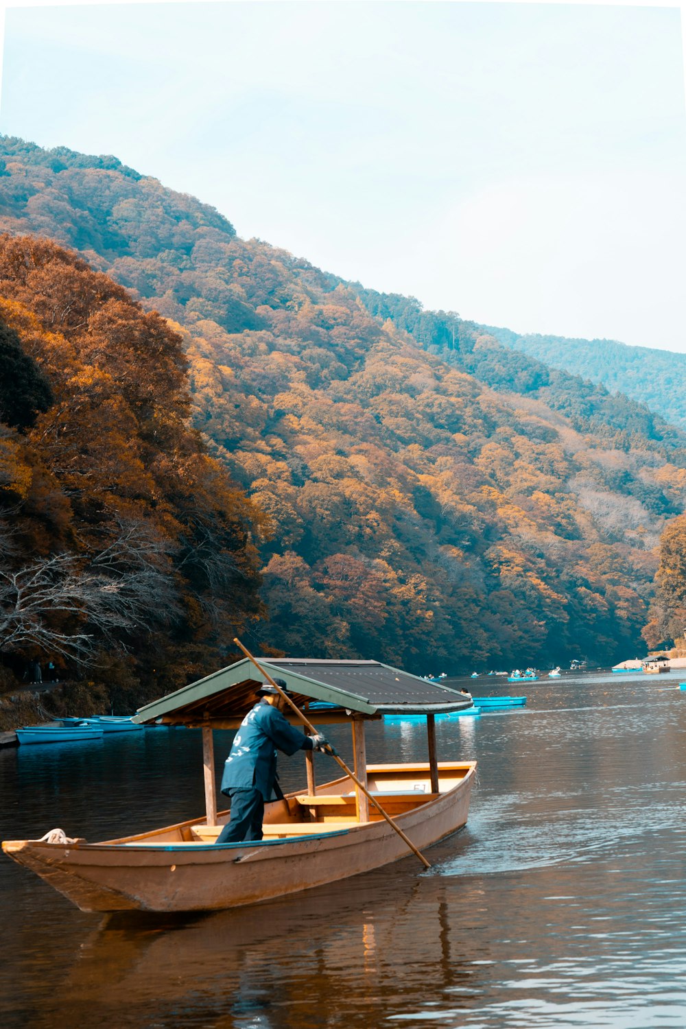 a man standing in a boat on a lake