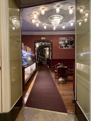 Warmly lit interior of Whitley Bay Masonic Hall set up for a private event with elegant decorations.