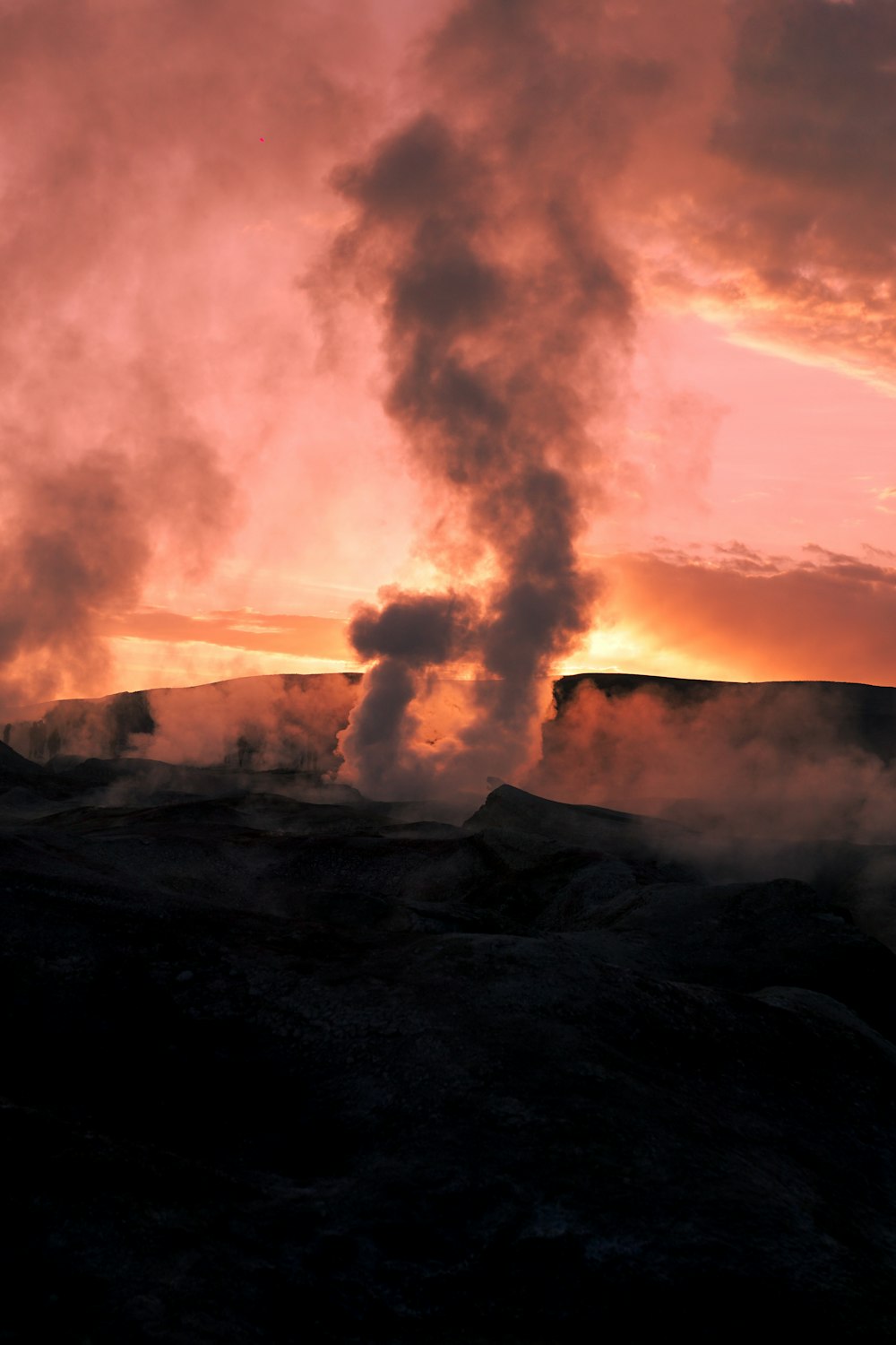 a group of smoke stacks rising into the sky