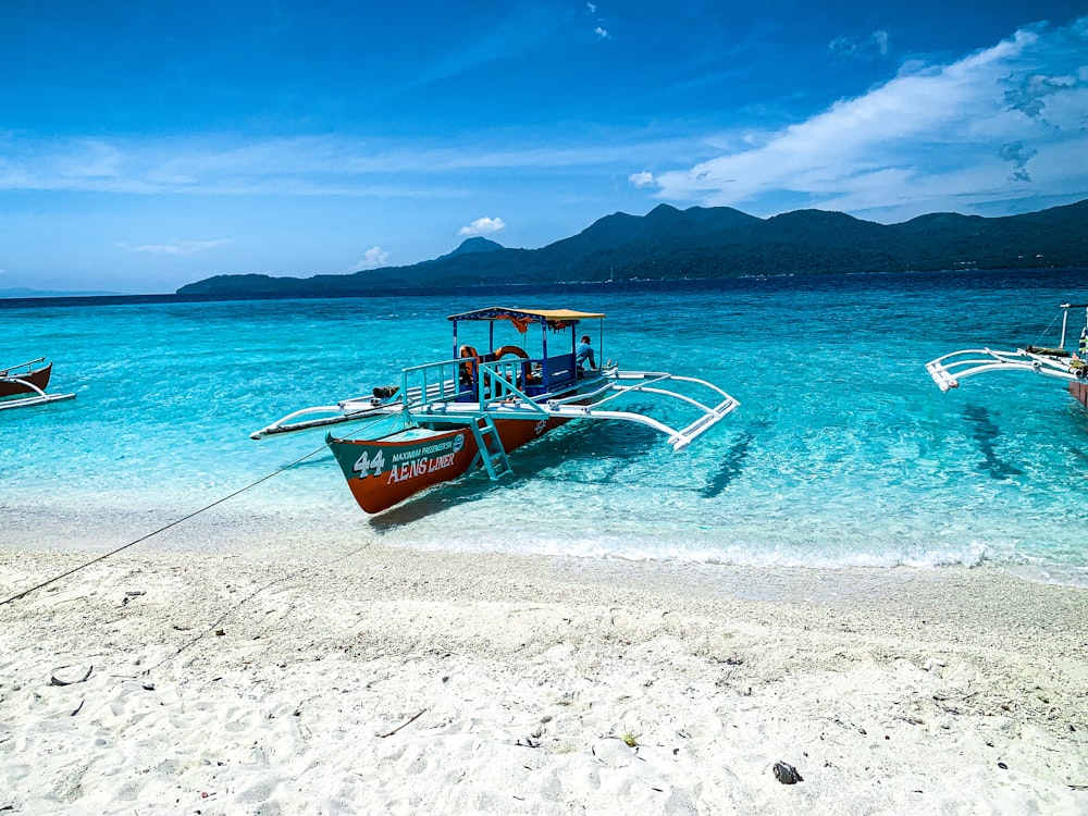 a couple of boats sitting on top of a beach