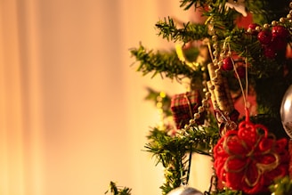 A cozy Christmas tree decorated with colorful handmade ornaments.