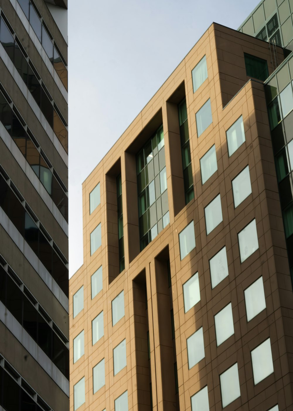 a tall building with lots of windows next to another building