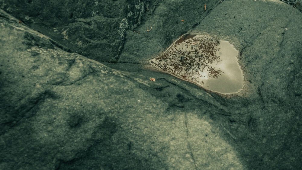 a puddle of water in the middle of some rocks