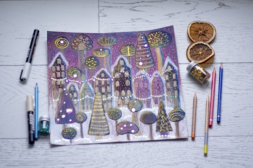 Jon Ksiazek sketching a whimsical winter scene on stage.