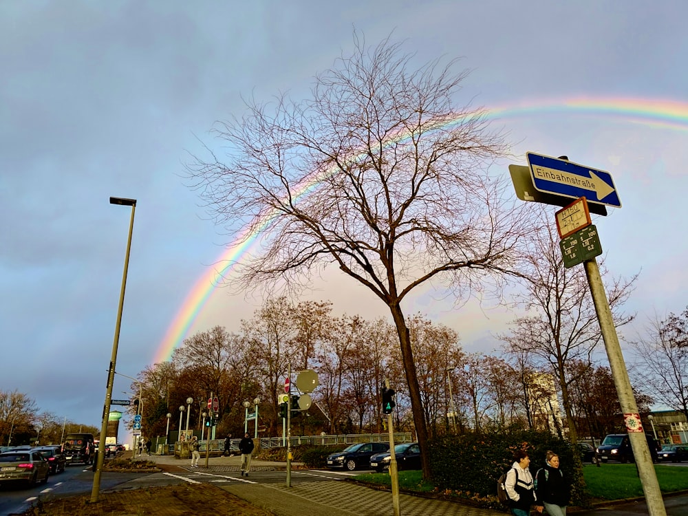 a double rainbow in the sky over a street