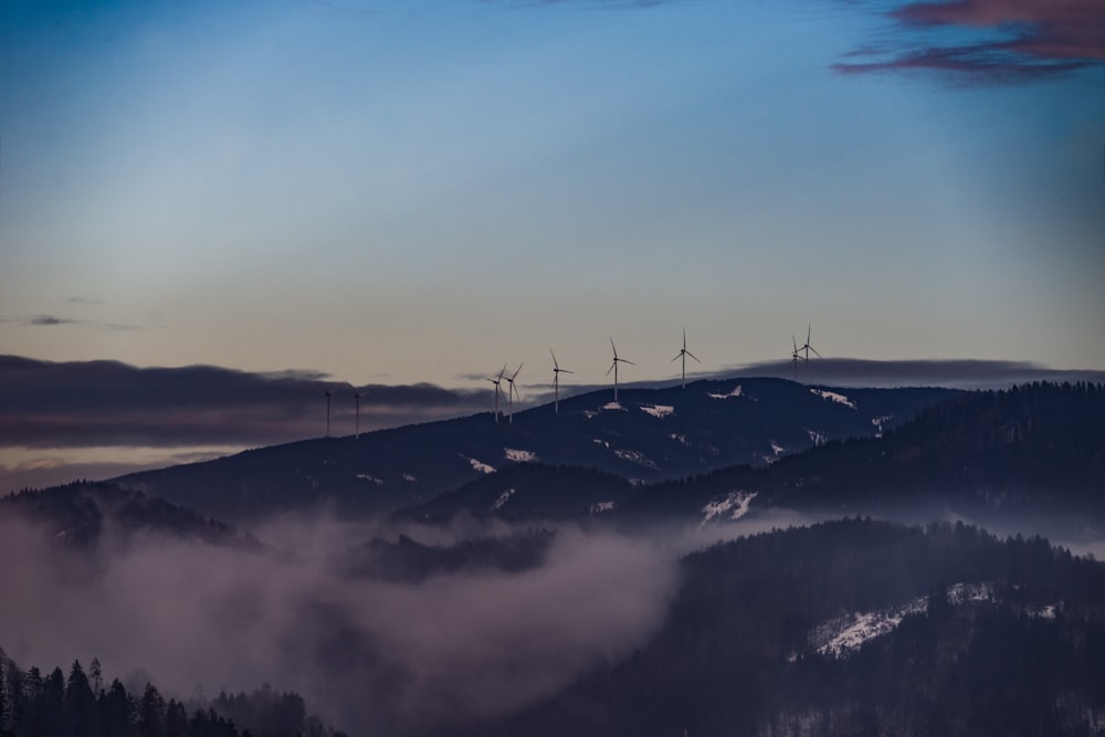 a group of wind mills on top of a mountain
