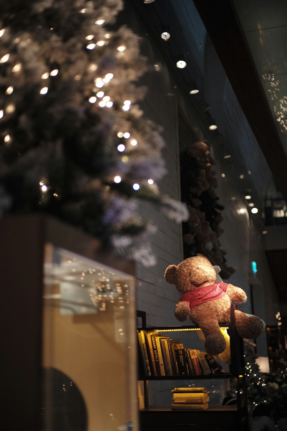 a teddy bear sitting on top of a shelf