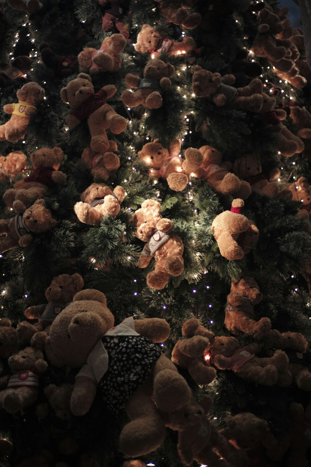 a large christmas tree with teddy bears on it