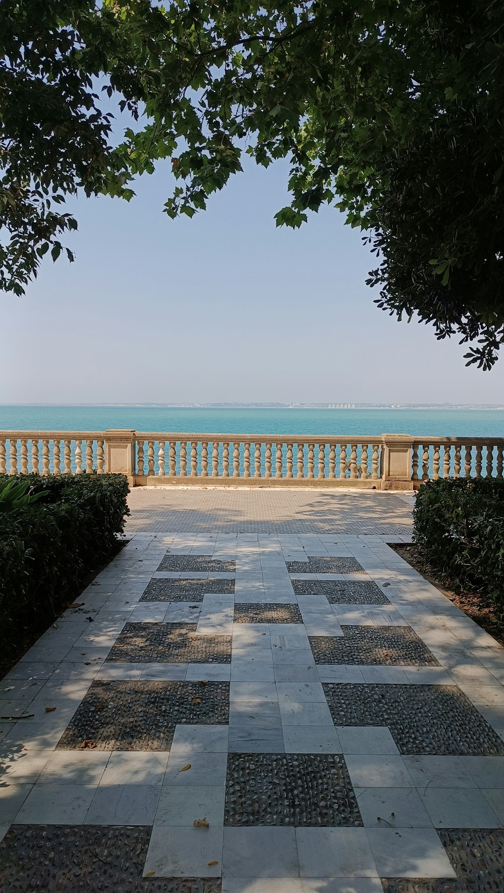 a view of the ocean from a park bench