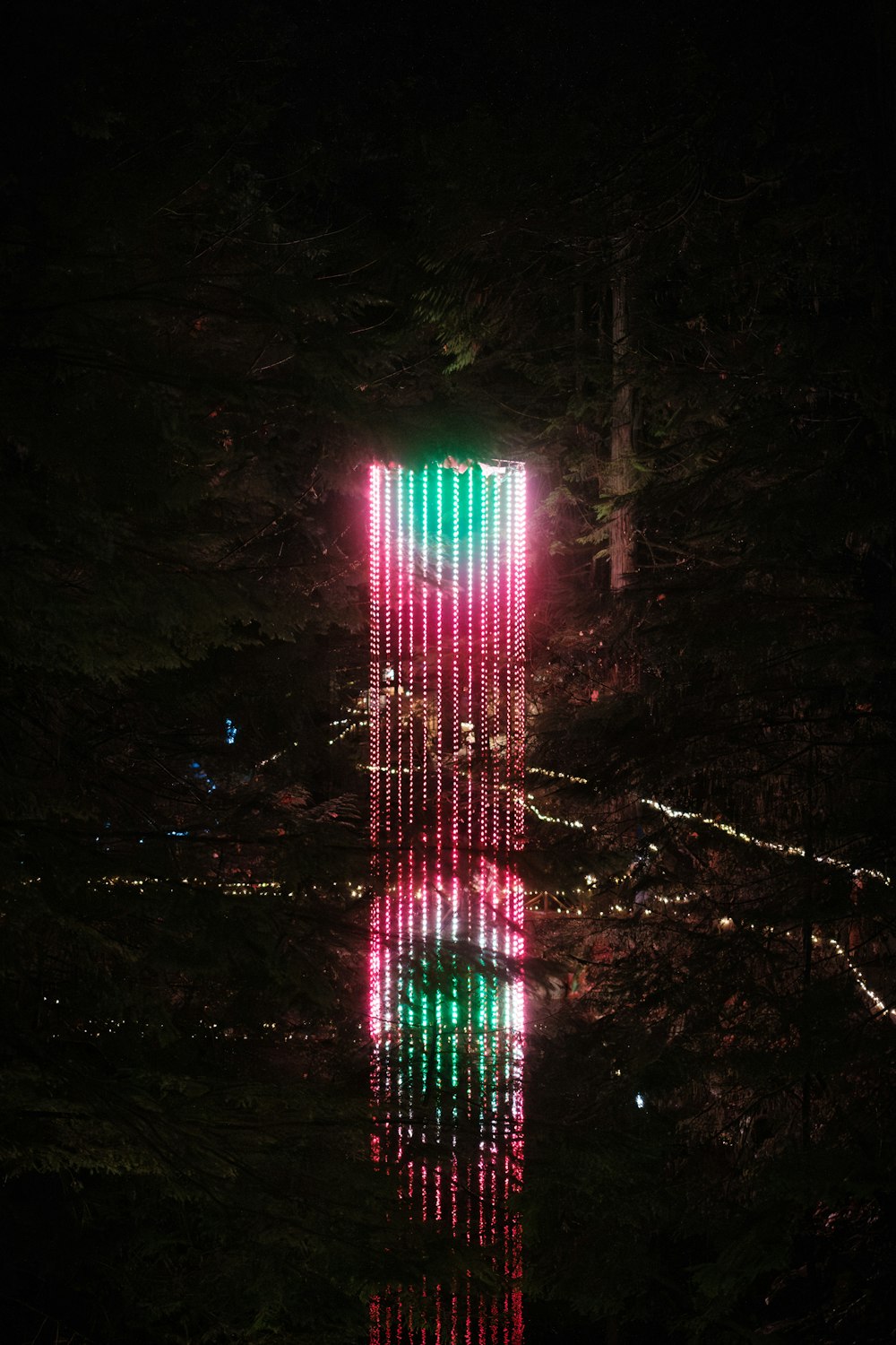 a tall building with a lot of lights on it's side