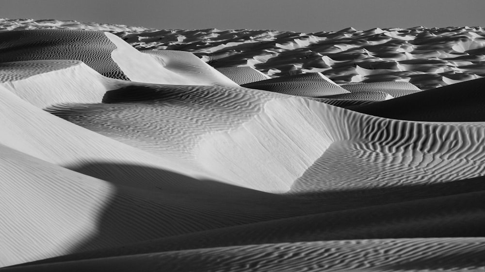 a black and white photo of sand dunes