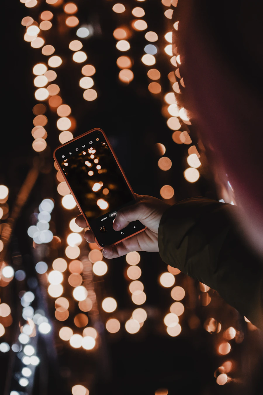 Person holding a smartphone with a warm glow