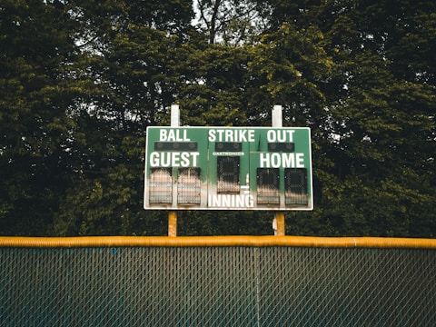 A scoreboard showing the current score of a youth softball game