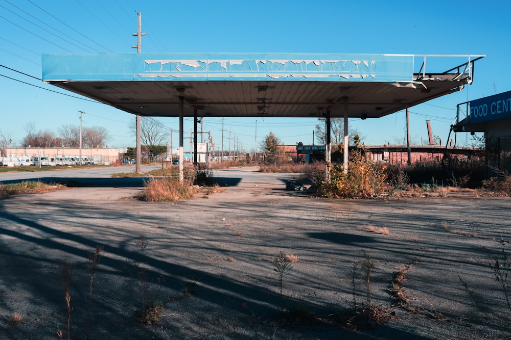 an empty gas station with a blue roof