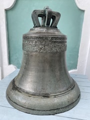Traditional brass bell hanging with intricate designs.