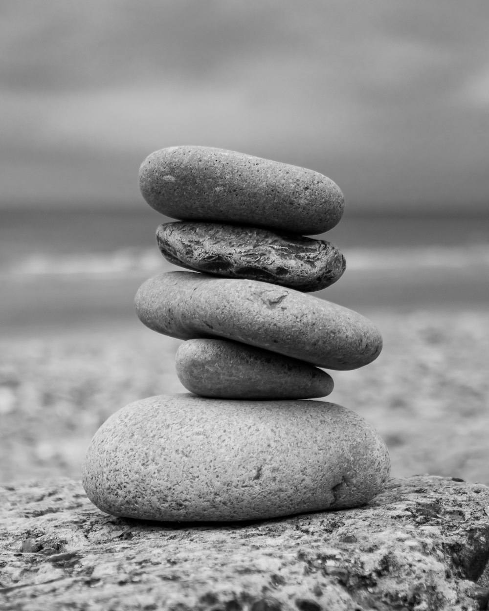 a stack of rocks sitting on top of a beach