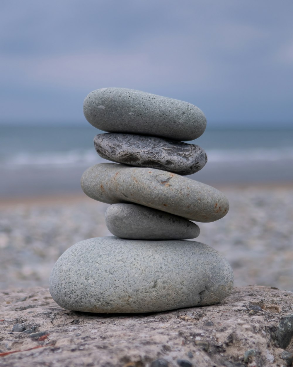 a stack of rocks sitting on top of a beach