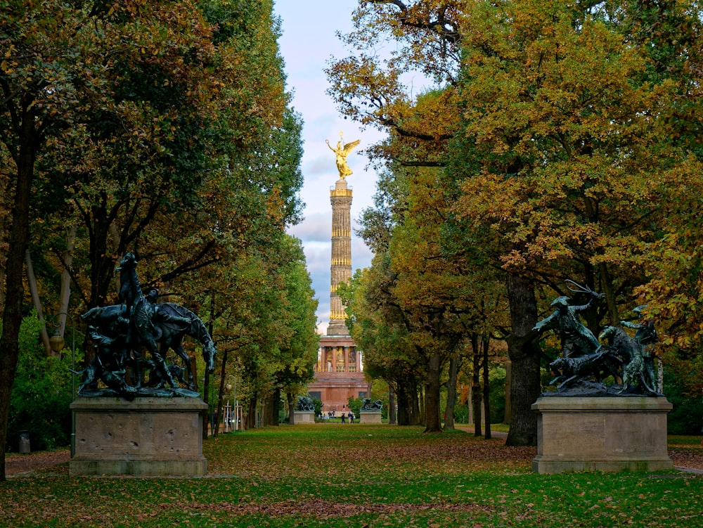 a view of a park with statues and trees