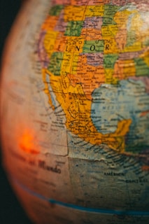 A close-up view of a globe depicting North America, with emphasis on Mexico and its surrounding regions. The image shows various cities and countries labeled, with clear borders and vibrant colors.