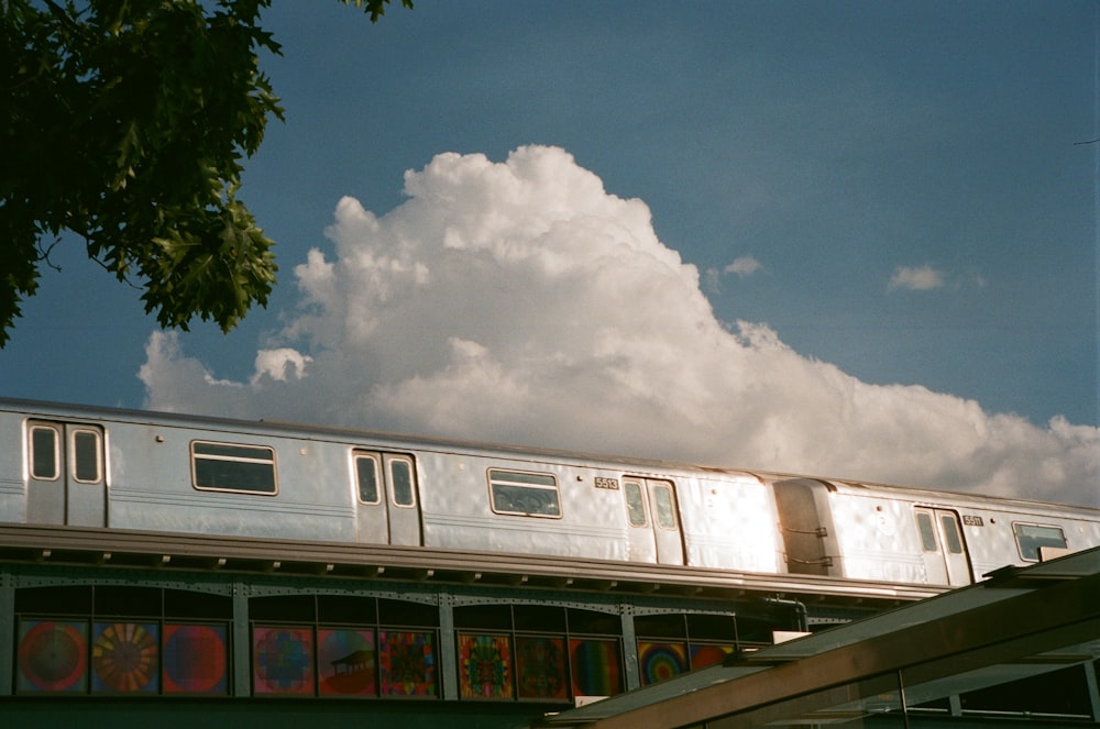 a train traveling over a bridge under a cloudy sky