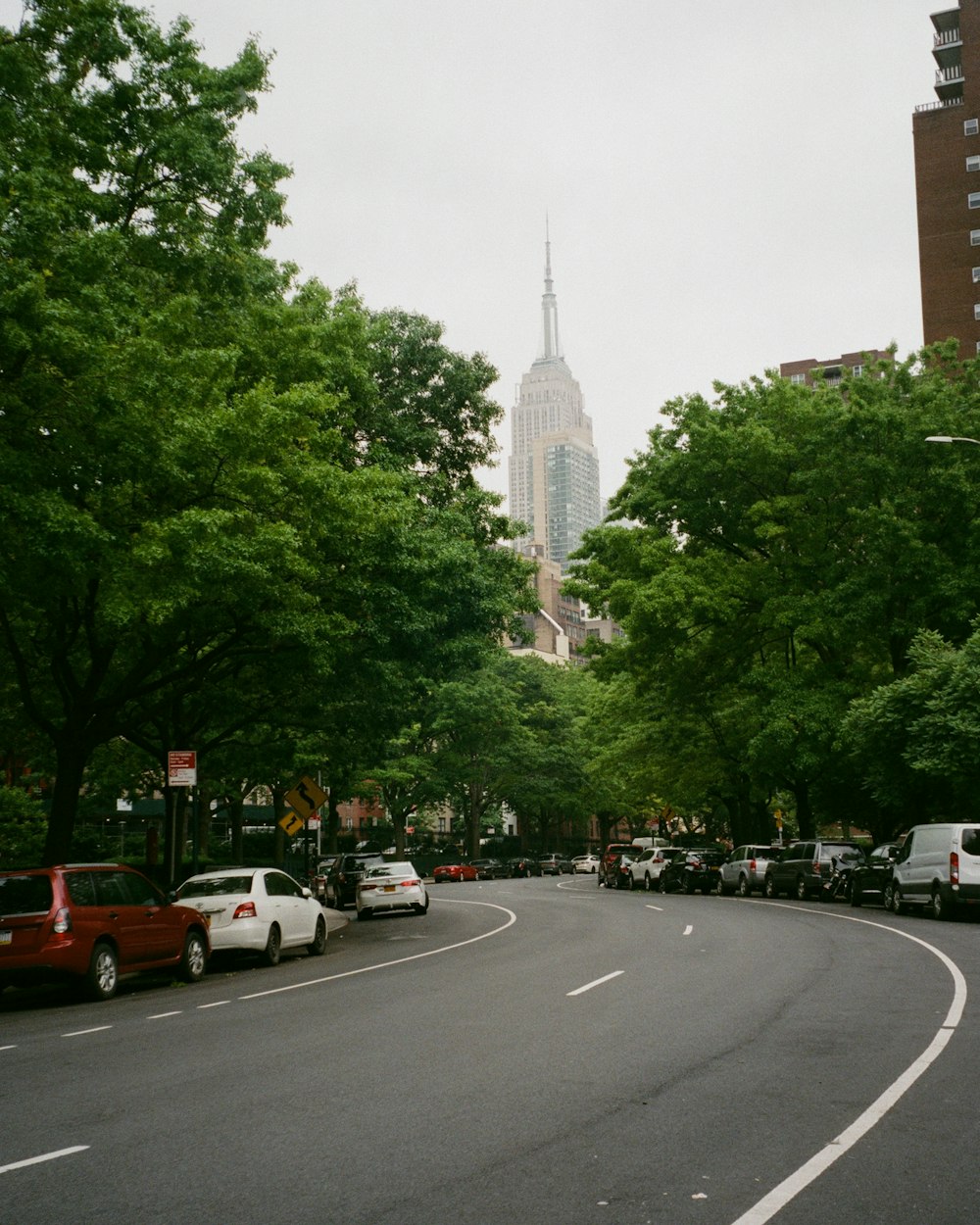 a street with cars parked on both sides of it