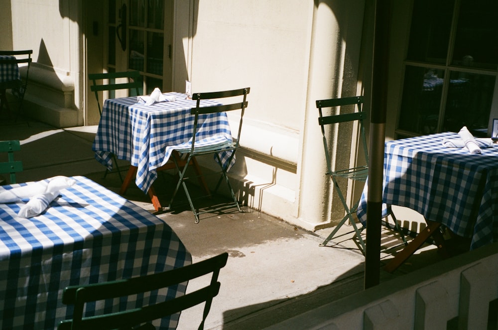 a couple of tables with blue and white checkered cloths