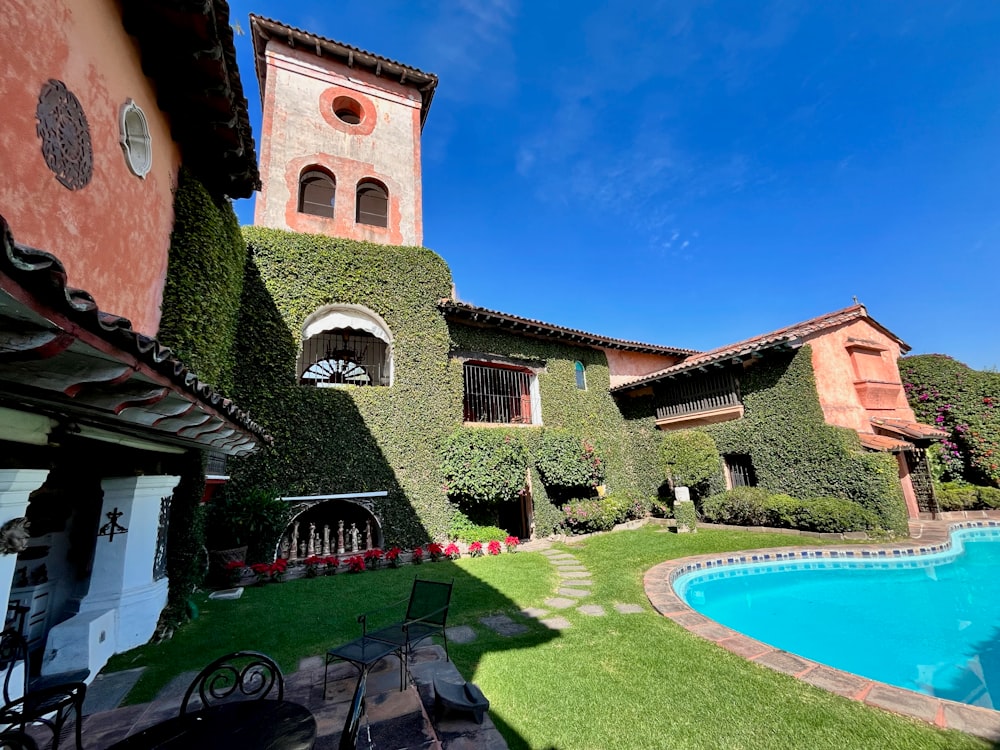 a house with a pool and a clock tower