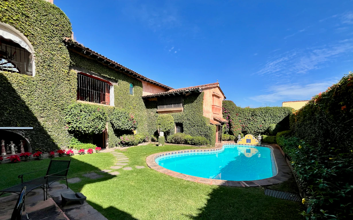 The tranquil lush pool courtyard of a restored Mexican home