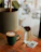 Close-up of a QR code sticker on a café table with a happy customer scanning it