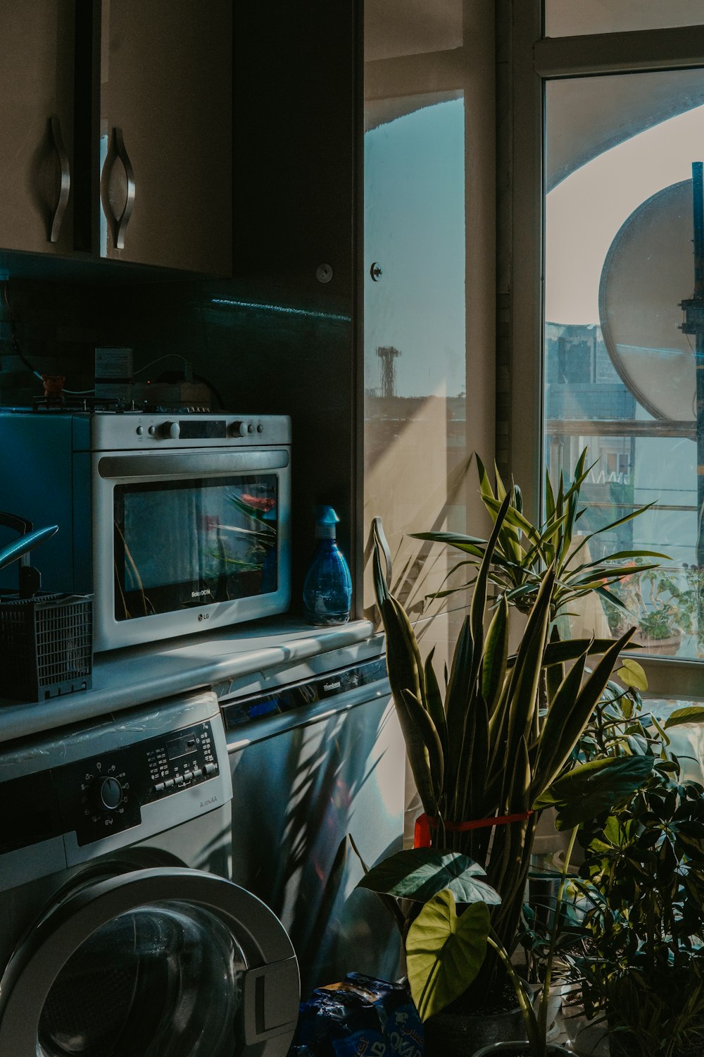 a kitchen with a washing machine and a window