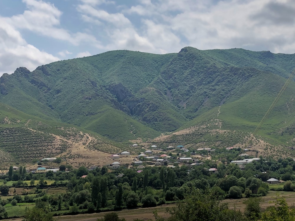 a mountain range with a village in the foreground