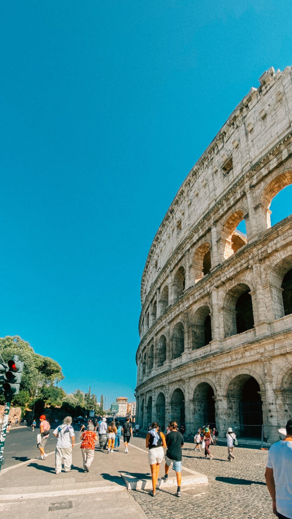 a group of people walking around an old building