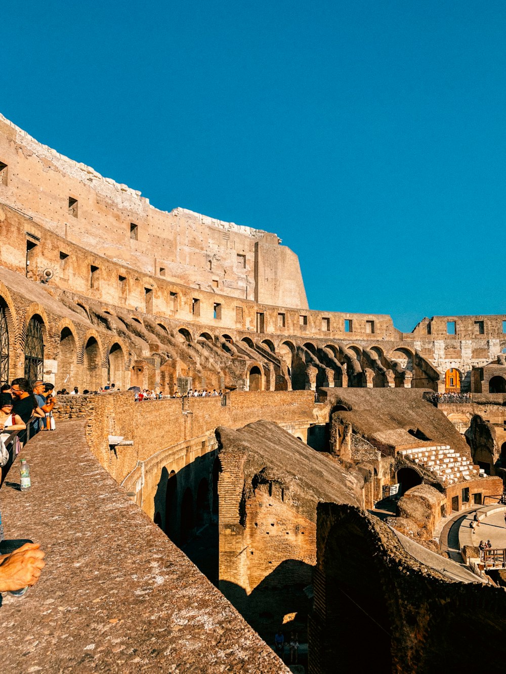 a group of people standing around a stone building