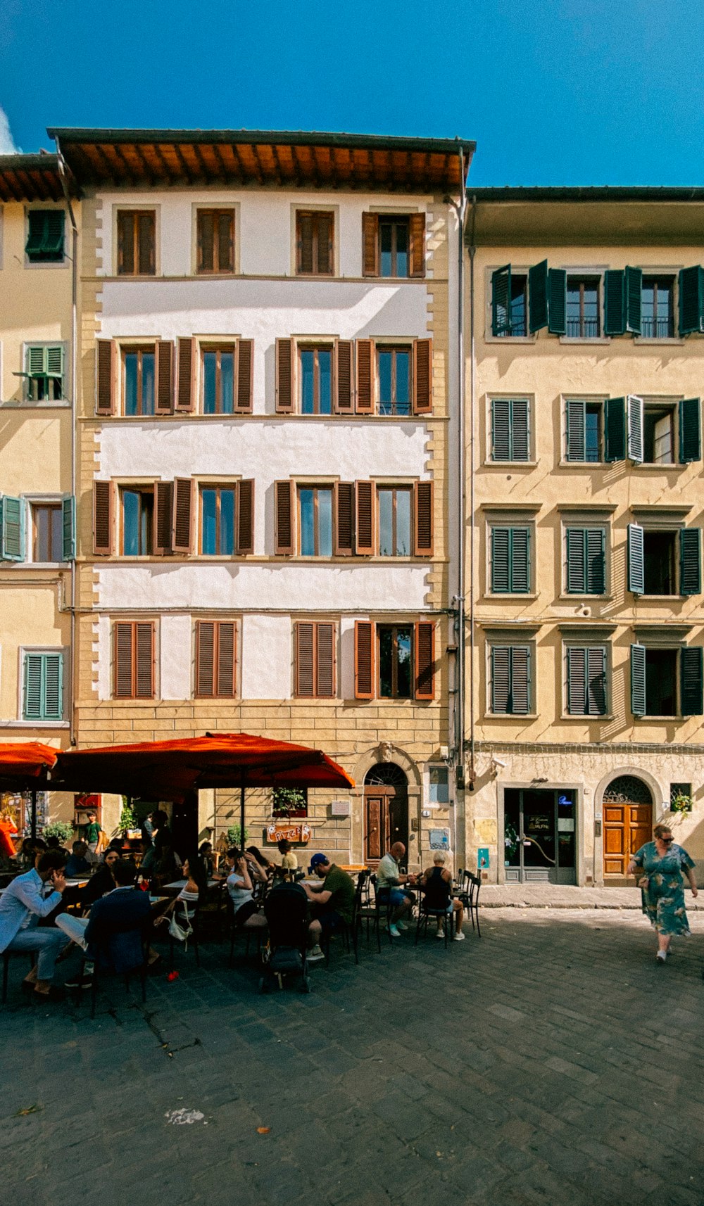 a group of people sitting outside of a building