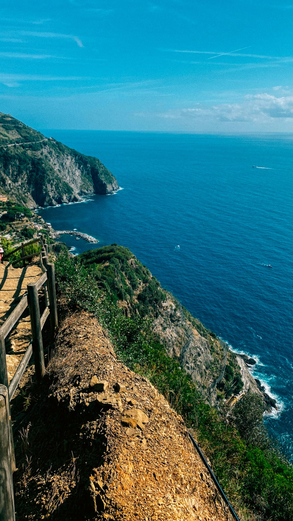 a bench sitting on the side of a cliff overlooking the ocean