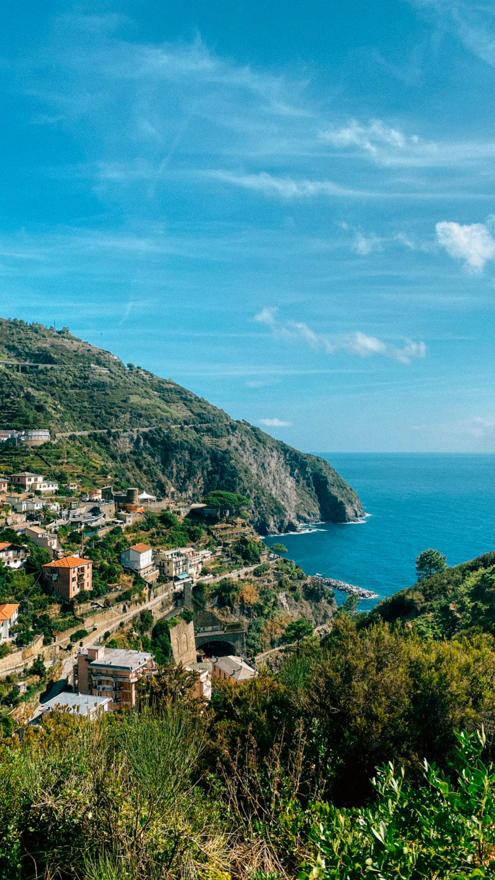 a scenic view of a small town on the side of a mountain