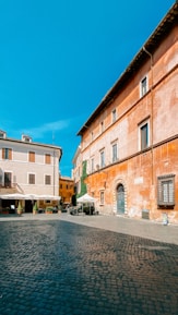 A traveler savoring a traditional meal in a cozy, sunlit courtyard.