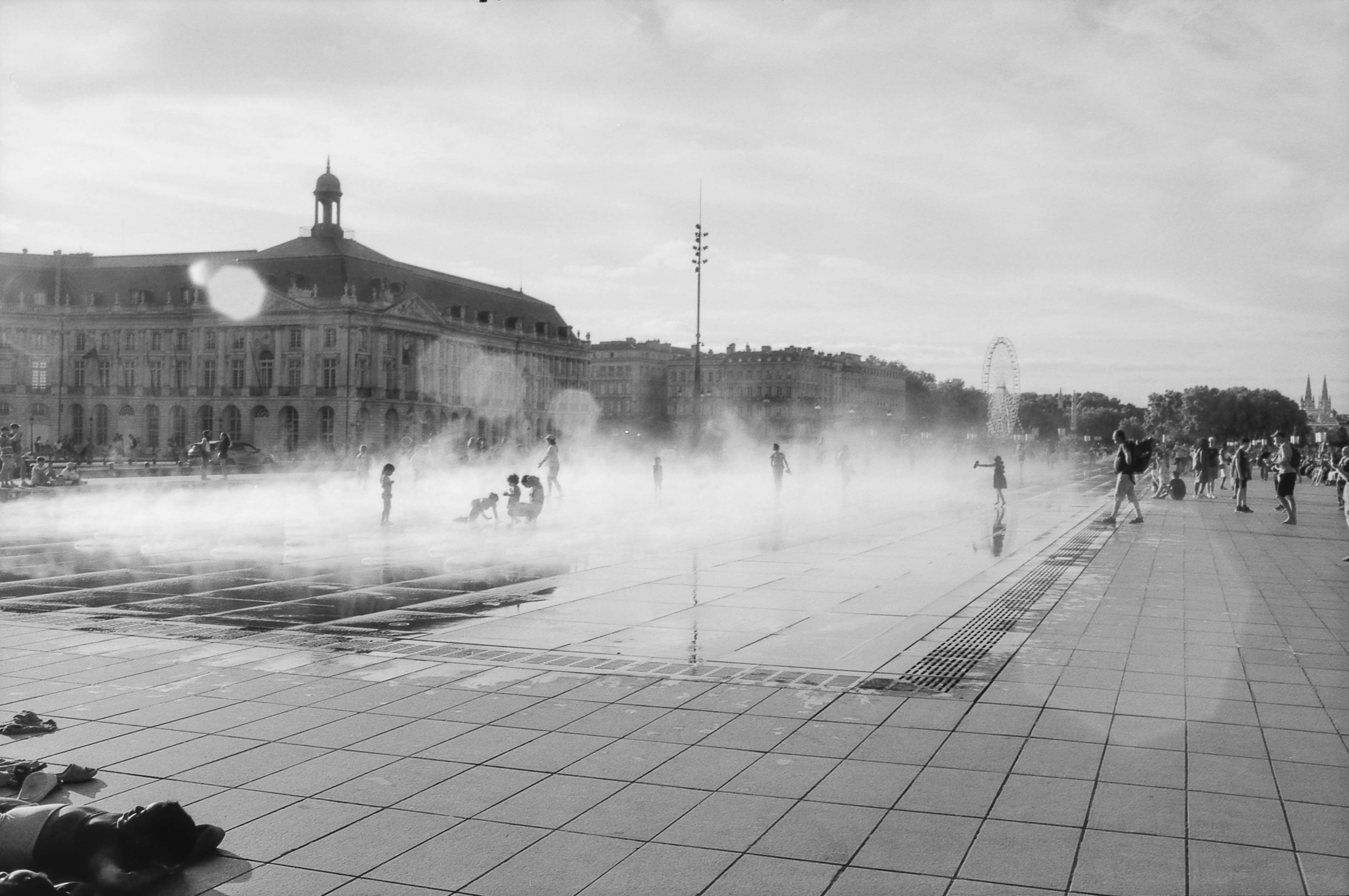 a black and white photo of a city square