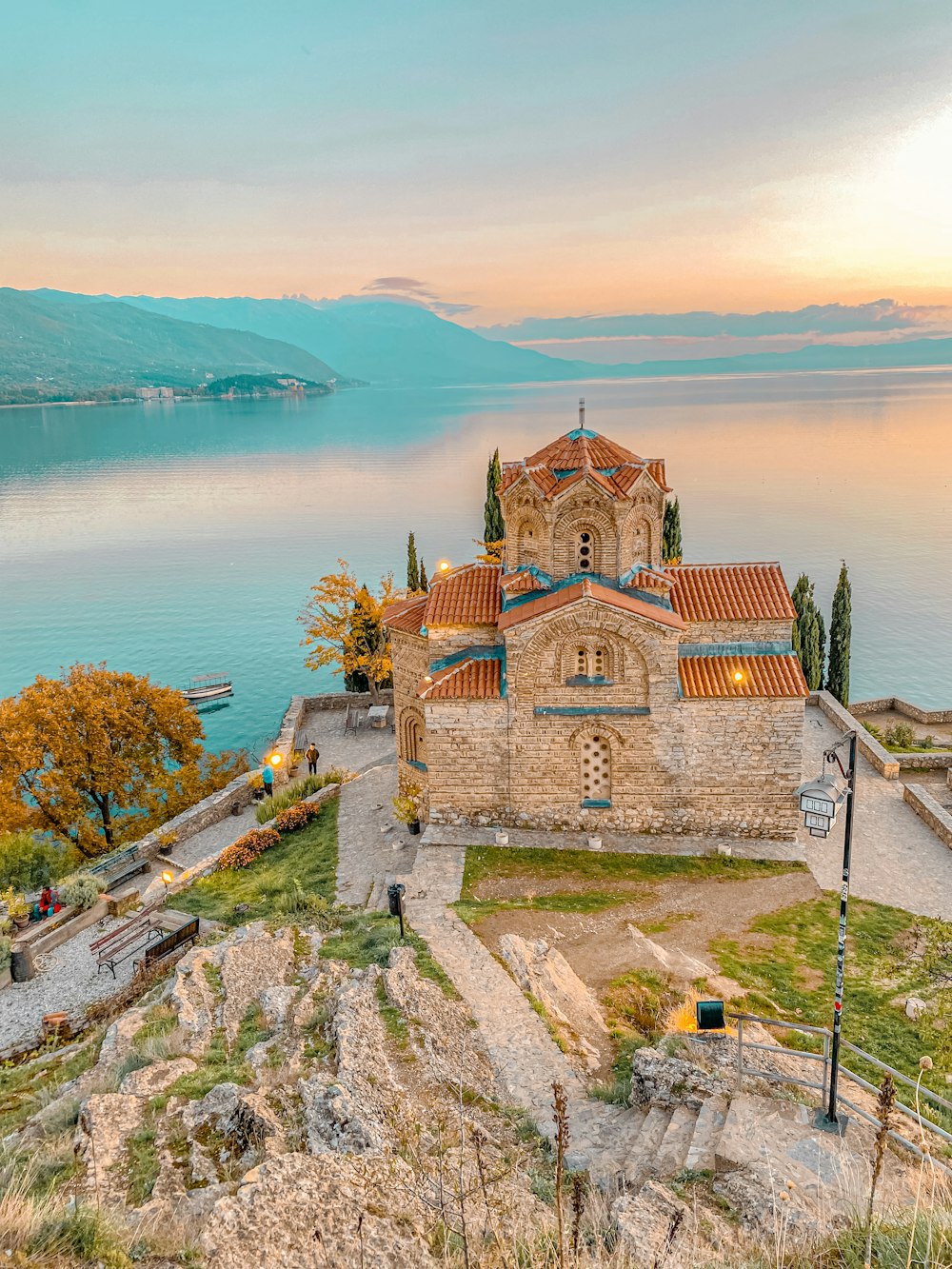a church on a hill overlooking a body of water