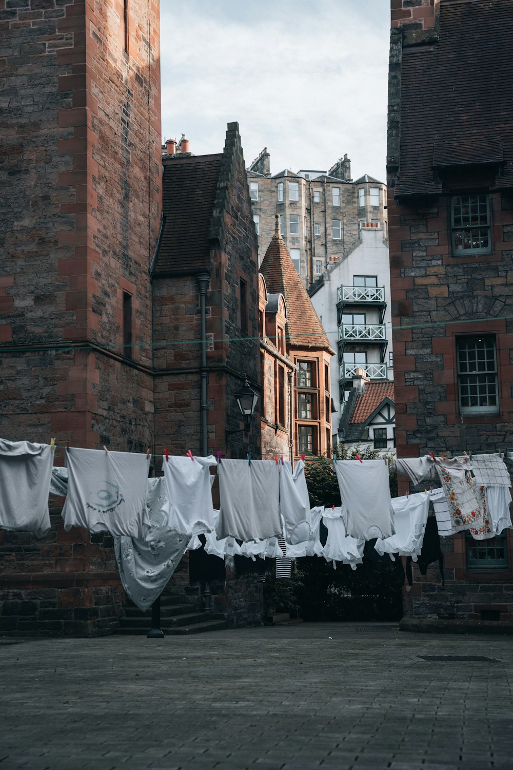 clothes hanging out to dry in front of a brick building