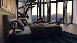 a bedroom with a spiral staircase in the corner