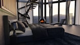 a bedroom with a spiral staircase in the corner